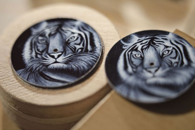 Gradually the design emerges in a meticulous piece of miniature painting, creating one of the big cats that is emblematic of Cartier jewellery, the hynotic tiger
