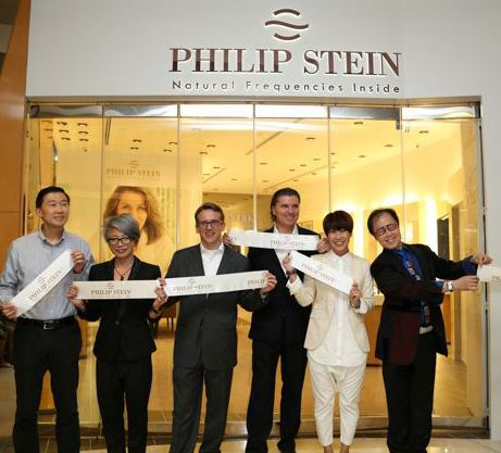 Founder and President of Philip Stein Group Will Stein (third from right) celebrates the opening of the boutique with fans