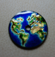 The tiny cloisonné dial depicting the world map